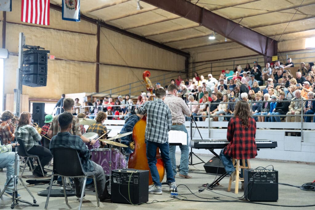 A student band performs for a packed crowd in the bleachers at the Indoor Arena